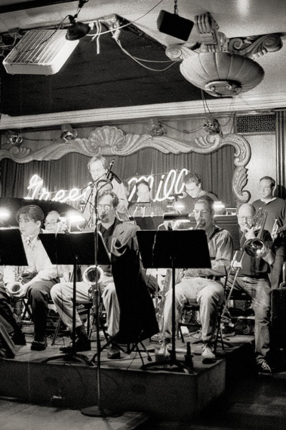 A big band completely fills, and even spills off of, the stage.