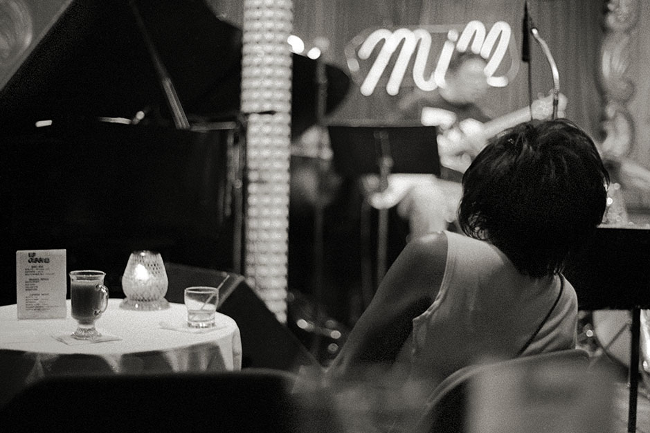 A woman sits near the stage.