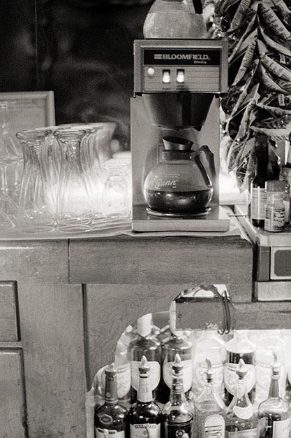 A half-full coffee pot sits behind the bar.