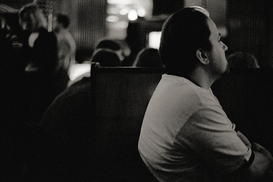 A man listens in the dark club.